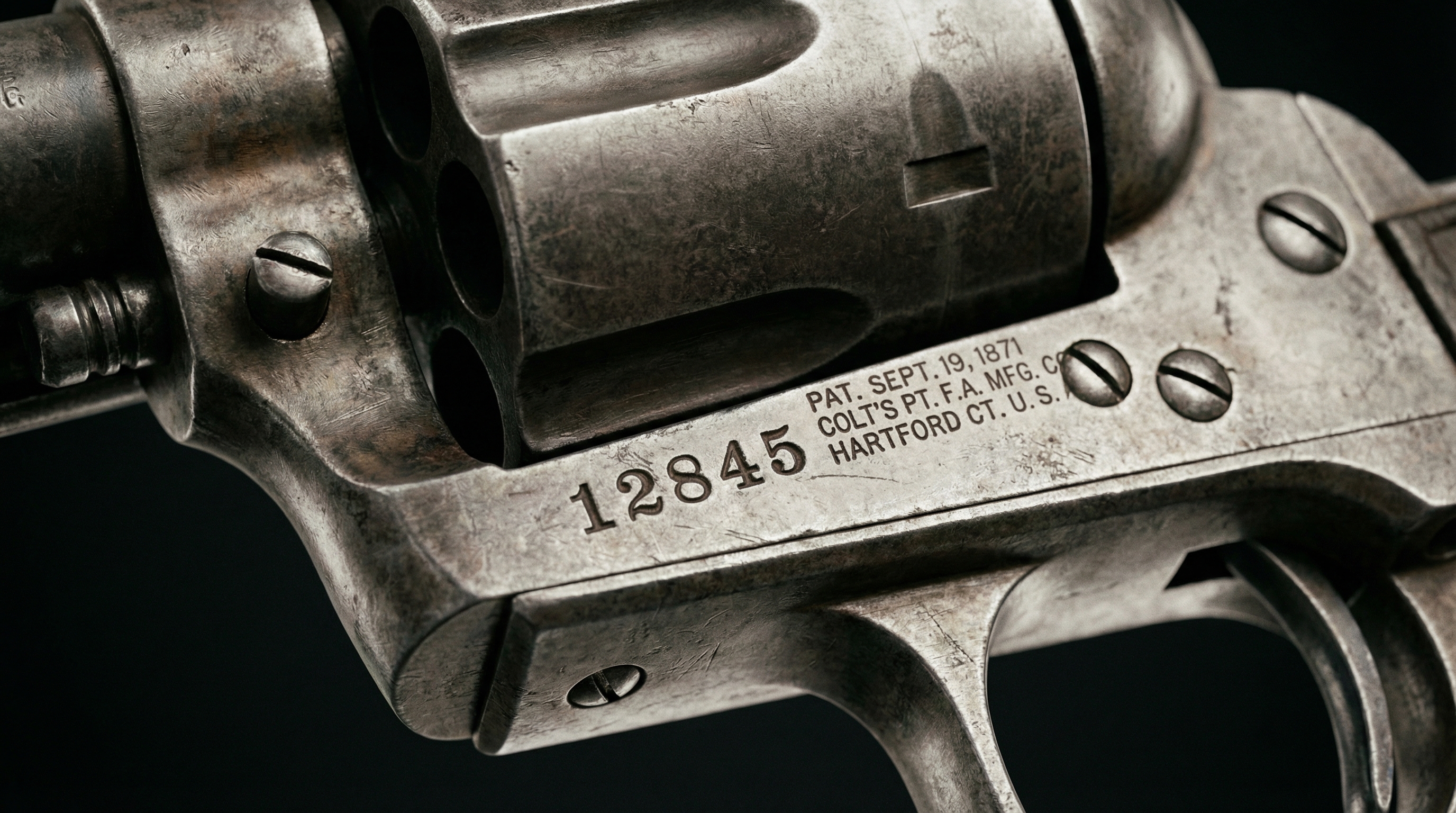 Close-up of antique revolver showing serial number and manufacturing marks
