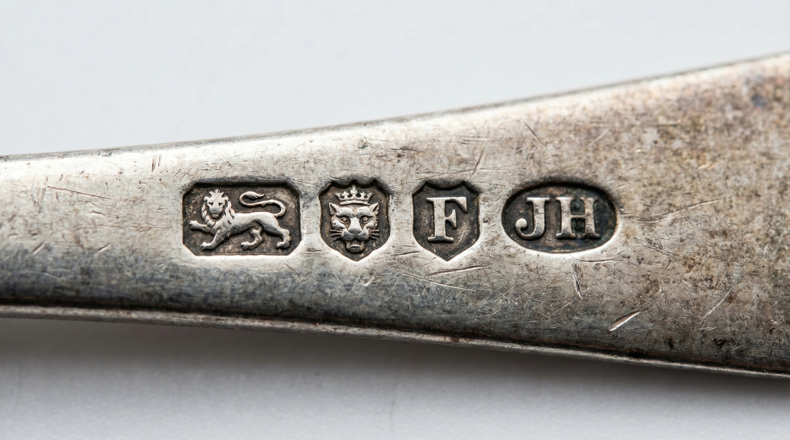 Close up of various silver hallmarks and makers marks