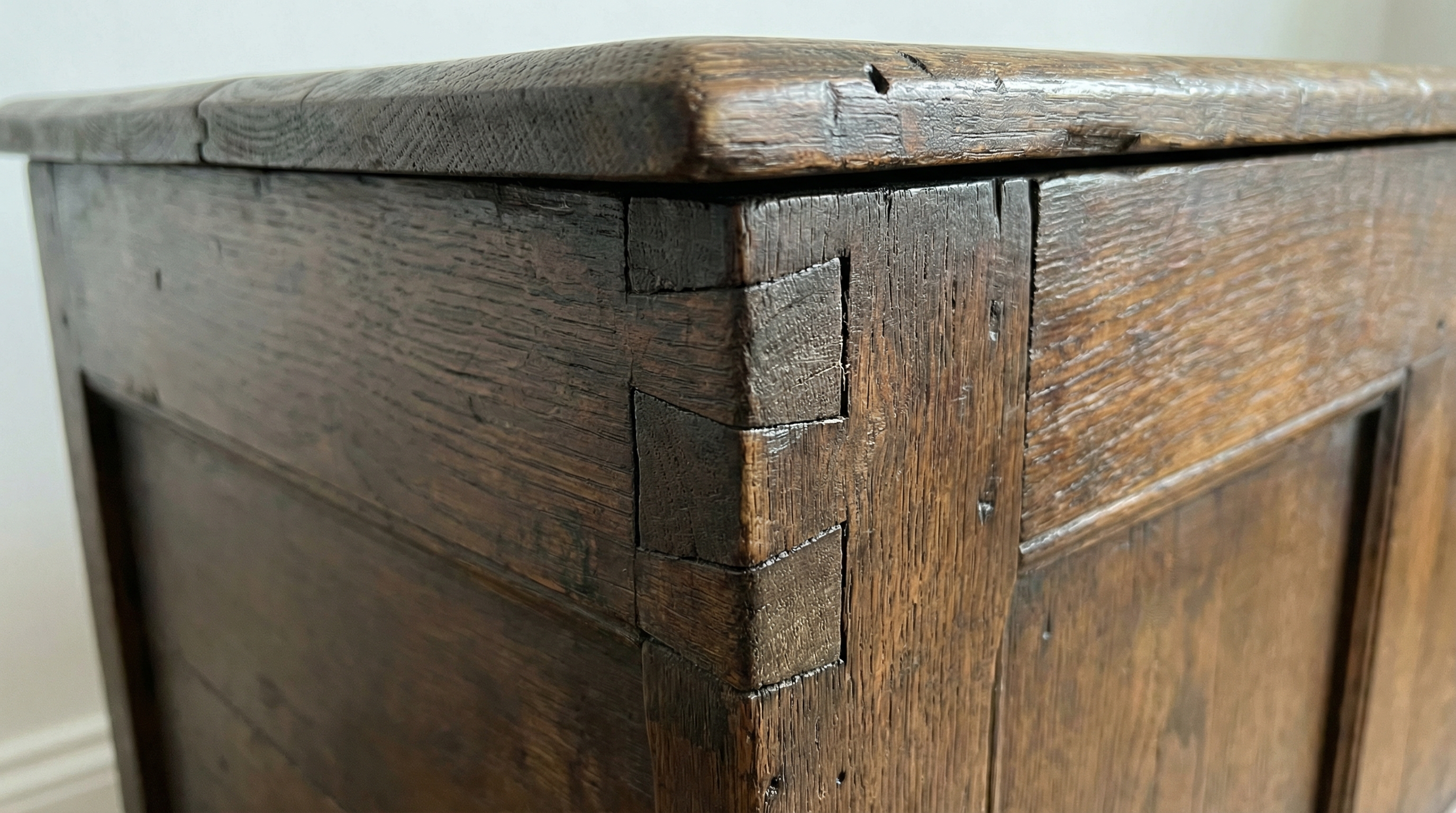 Close-up of antique furniture joinery details showing dovetail joints and craftsmanship