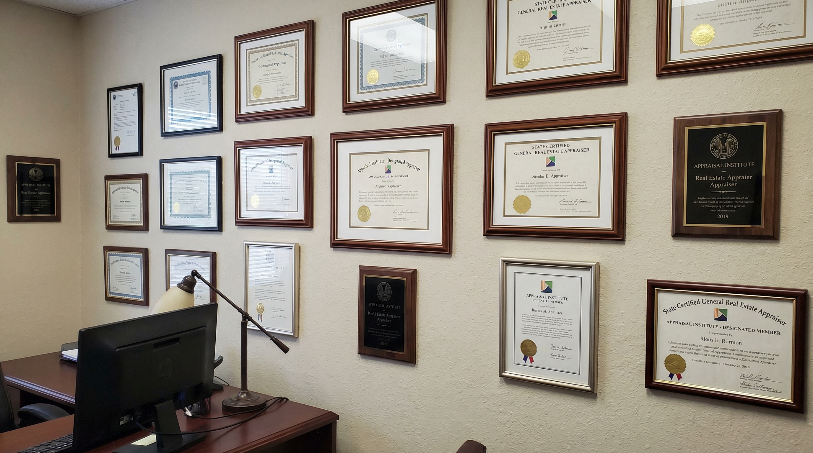 certificates and credentials displayed on appraiser's office wall
