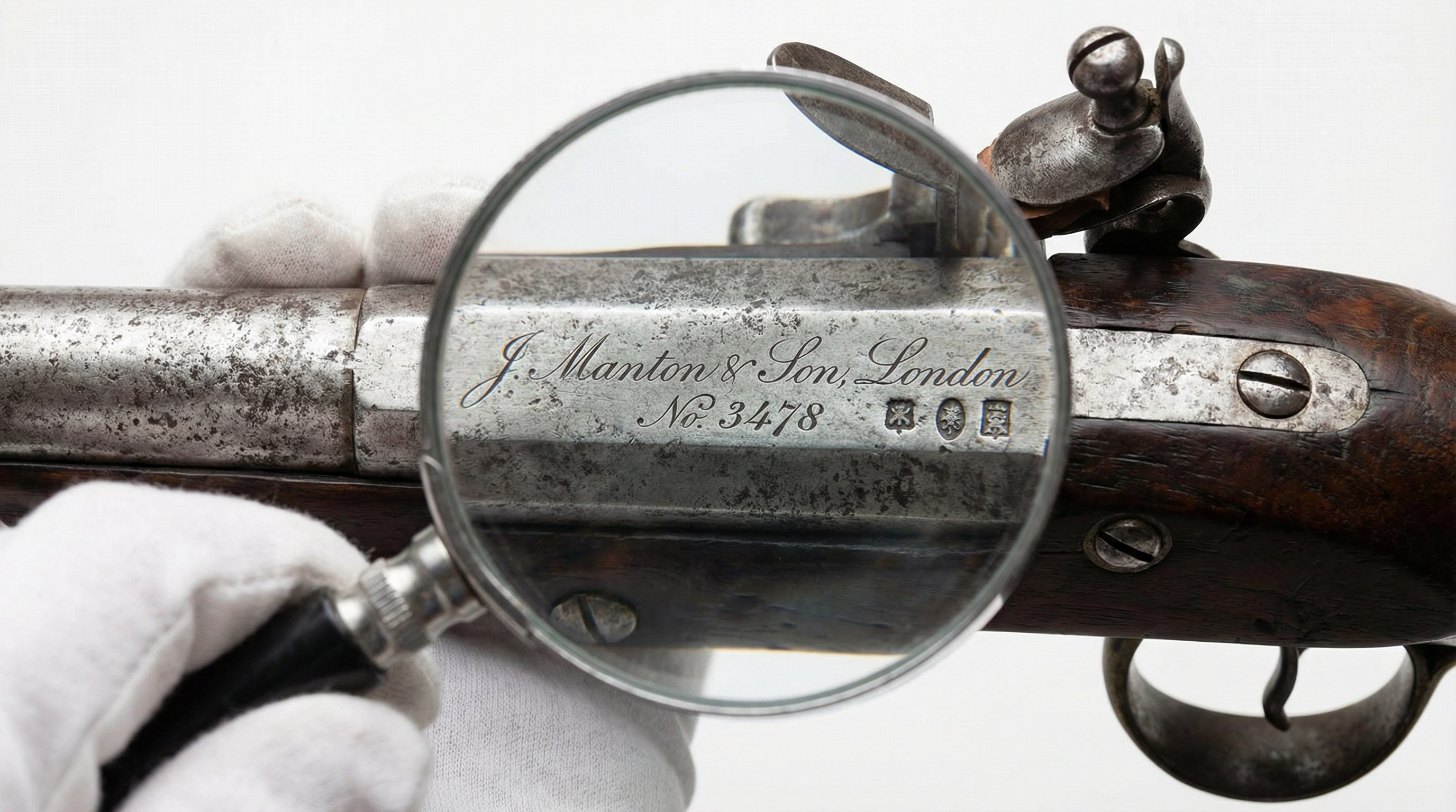 Close up of antique gun markings and serial numbers being examined
