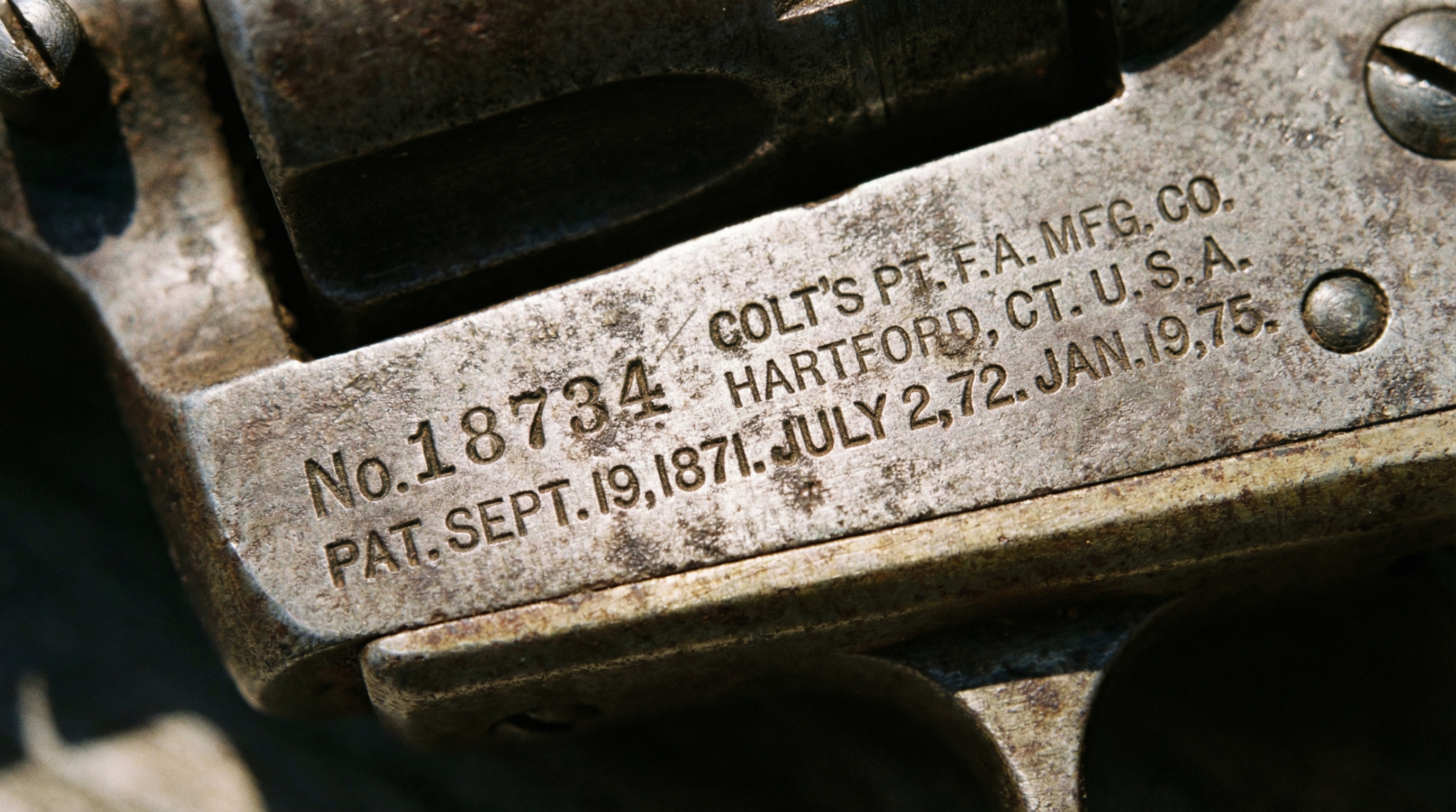 Close-up detailed view of antique gun markings showing serial numbers and manufacturer stamps