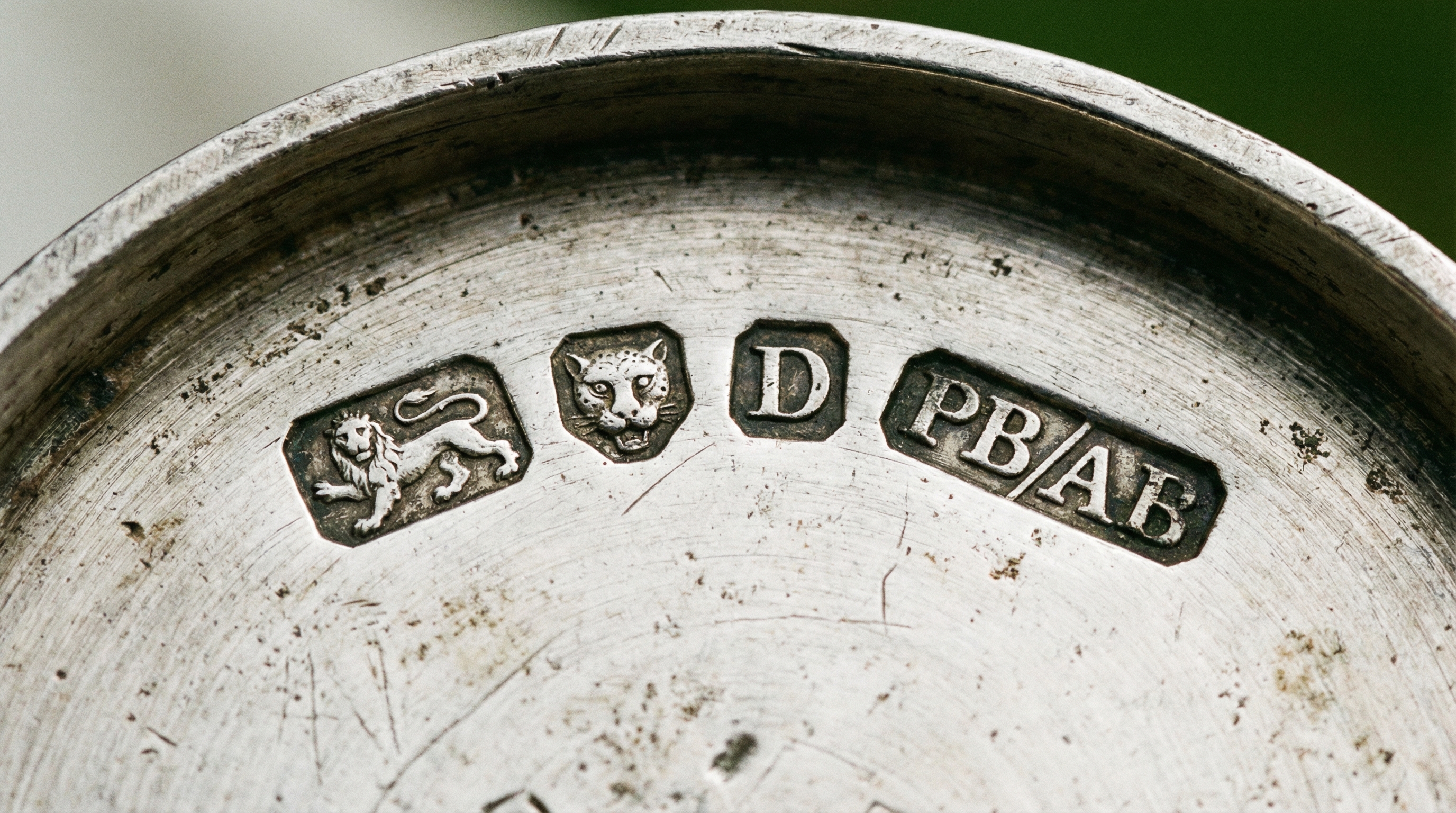close-up of antique silver hallmarks and maker's marks