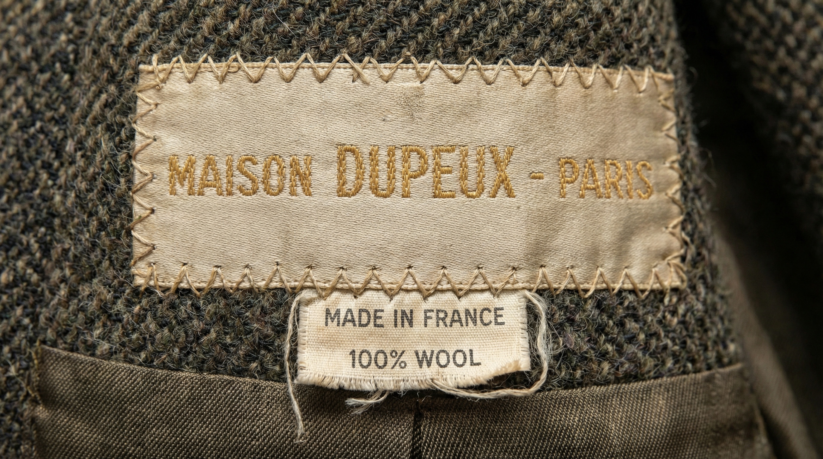 Close-up of vintage designer label showing authentic construction details